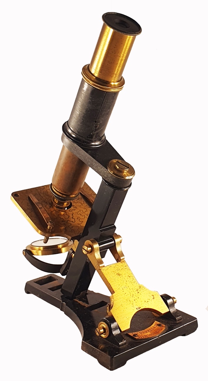 A close-up of a microscopeDescription automatically generated
