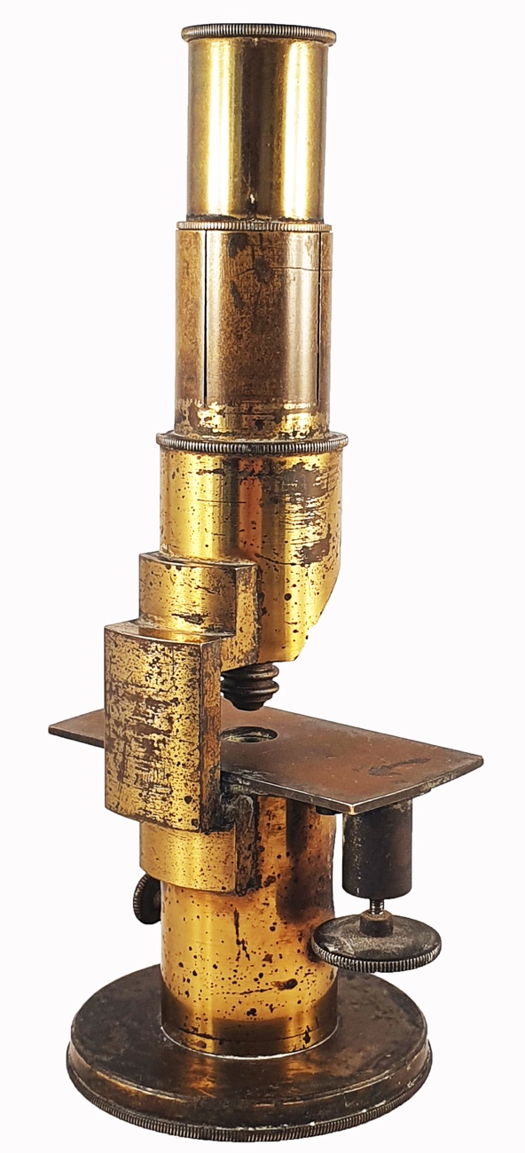 A close-up of a gold microscopeDescription automatically generated