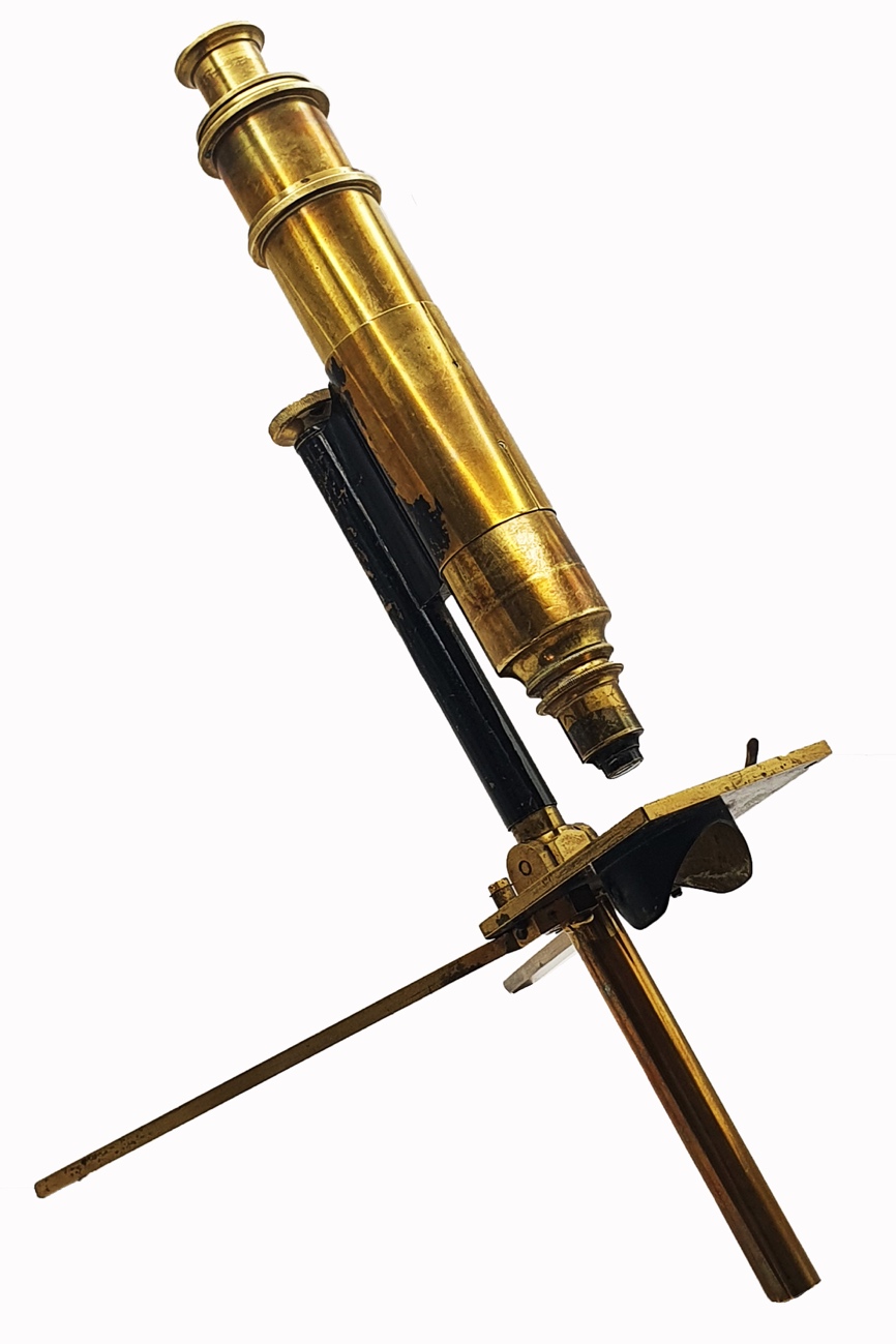 A close-up of a gold microscopeDescription automatically generated