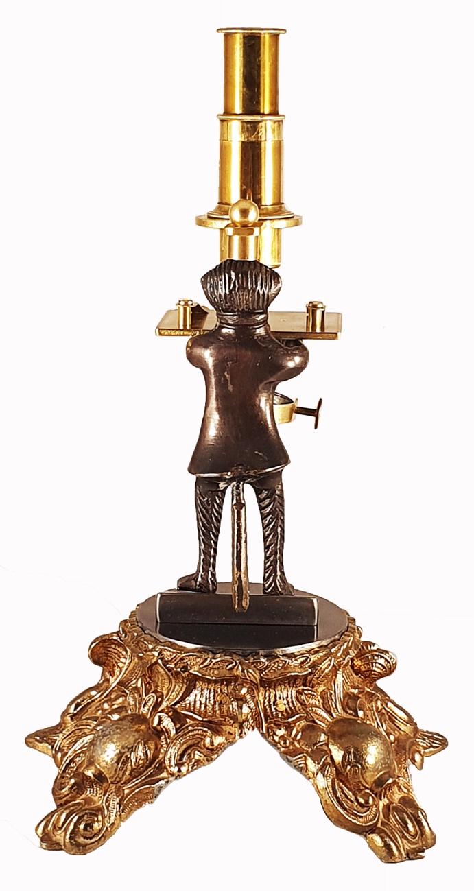 Microscope Statue A statue of a person holding a lampDescription automatically generated