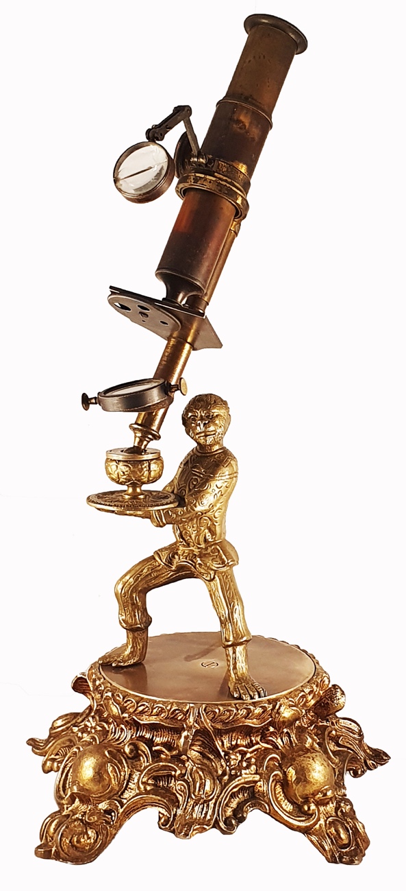 Microscope Statue A gold statue of a person holding a microscopeDescription automatically ...